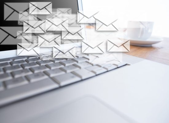Digital composite of New mails appearing beside laptop